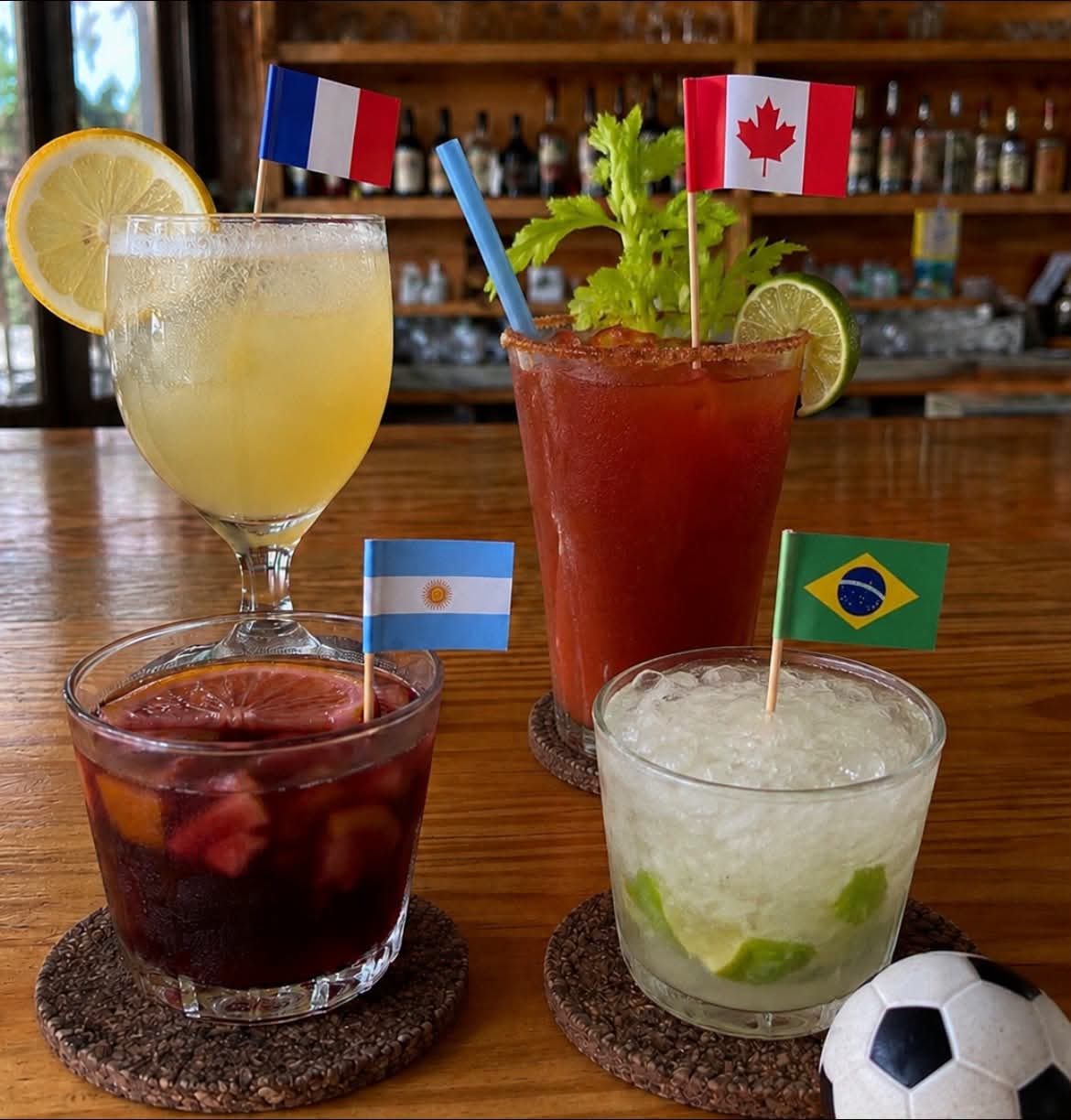 Four cocktails with French, Canadian, Argentine and Brazilian flags